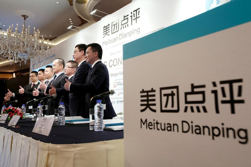 FILE PHOTO: The management team of China's Meituan Dianping, an online food delivery-to-ticketing services platform, attends a news conference on its IPO in Hong Kong, China September 6, 2018.   REUTERS/Bobby Yip/File Photo