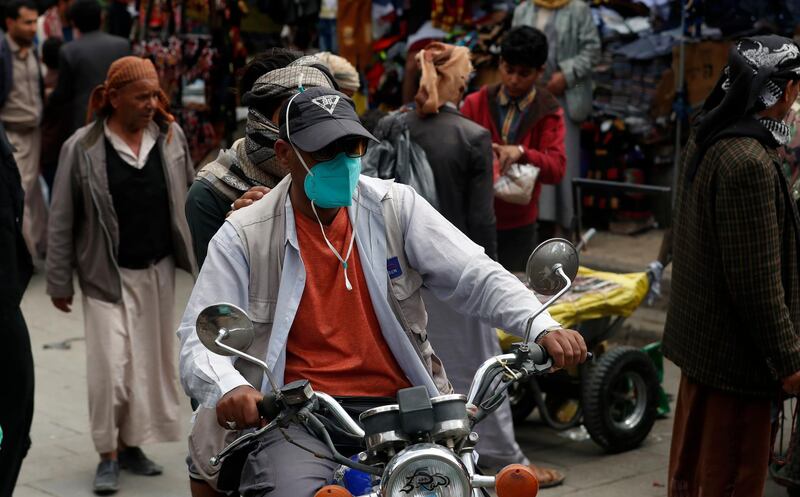 A Yemeni motorcyclist wears a protective face mask  at a market in Sanaa, Yemen.  EPA