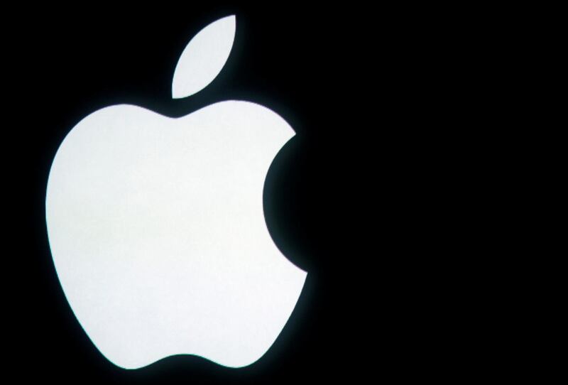 FILE PHOTO: The Apple logo is displayed onstage before a product unveiling event at Apple headquarters in Cupertino, California October 4, 2011.  REUTERS/Robert Galbraith/File Photo