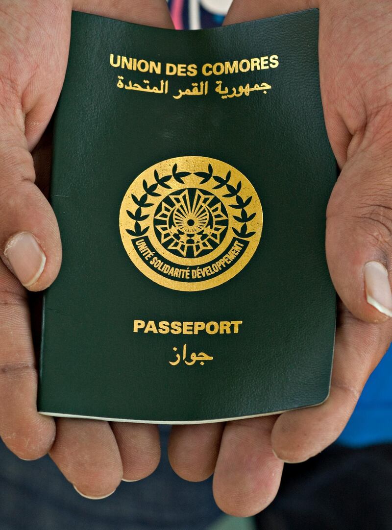 RAS AL KHAIMAH, UNITED ARAB EMIRATES - July 30, 2012 - Jalal Mohamad Balooshi holds hist passport from the country of Union des Comores, allowing him to remain in the UAE living in the village of Shamal in Ras al Khaimah City, Ras al Khaimah, July 30, 2012. (Photo by Jeff Topping/The National) 