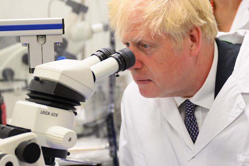 Prime Minister Boris Johnson looks into an electron microscope in a laboratory at the Francis Crick Institute on Monday in London. Getty Images