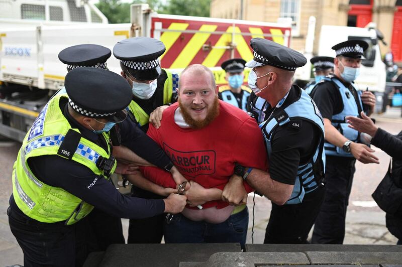 A protestor is arrested for breaching the peace during a demonstration outside the Town Hall in Batley. AFP