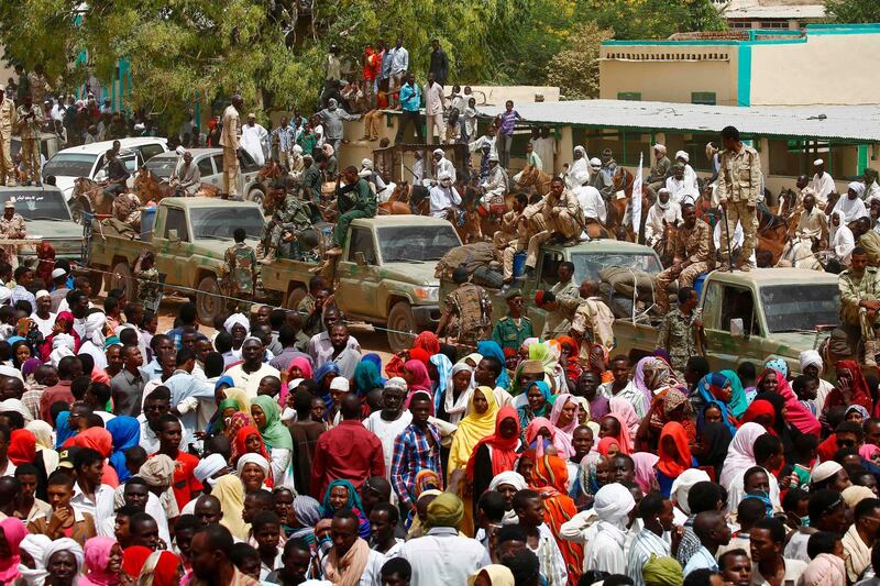 (FILES) In this file photo taken on April 2, 2016, A convoy of Sudanese security forces deploy during a rally in al-Geneina, the capital of the West Darfur state. Ongoing clashes in Sudan's restive Darfur have killed at least 48 people in two days, state media said, just over two weeks after a long-running peacekeeping mission ended operations. The violence has pitted the Massalit tribe against Arab nomads in El Geneina, the capital of West Darfur state, but later morphed into broader fighting involving armed militias in the area. / AFP / ASHRAF SHAZLY

