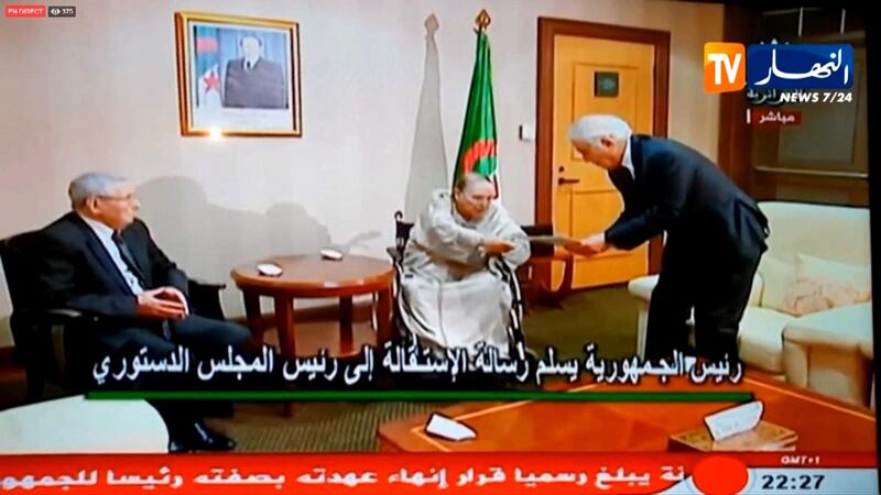 This tv grab taken on April 2, 2019, from Ennahar TV shows Algerian ailing President Abdelaziz Bouteflika (C) giving his resignation letter to the Constitutional Council's president Tayeb Belaiz in front of the President of the Algerian Senate Abdelkader Bensalah (L) in Algiers. - Algeria's veteran President Abdelaziz Bouteflika informed the Constitutional Council that he is resigning in a move that is to take effect on Tuesday, state television said. Under the constitution, once his resignation is tendered, the speaker of Algeria's upper house of parliament, Abdelkader Bensalah, would act as interim leader for up to 90 days during which a presidential election must be organised. (Photo by - / ENNAHAR TV / AFP)