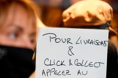 A signs in a Paris shop window reads 'for delivery and click and collect call'. AFP