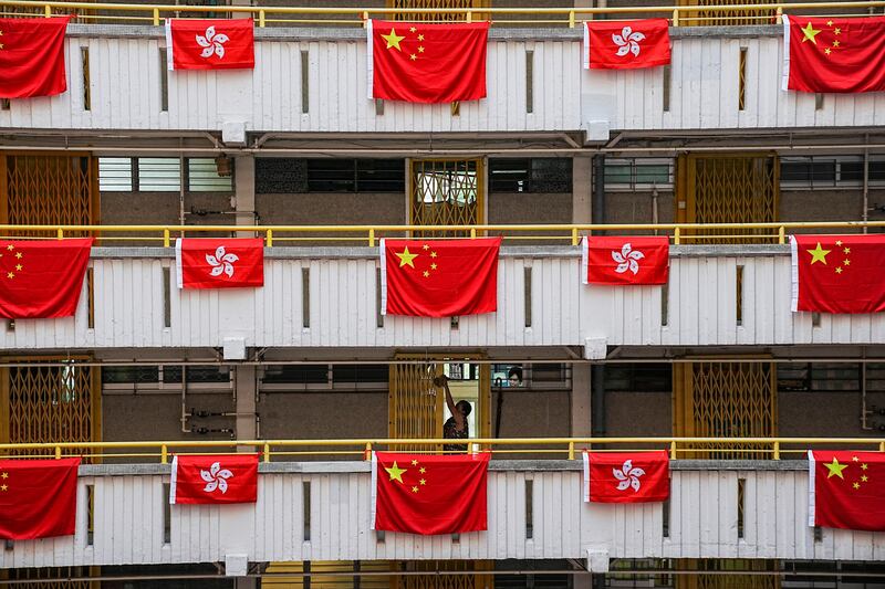 Chinese and Hong Kong flags decorate a residential building in the city on June 26 to mark the 25th anniversary of Hong Kong’s handover to China from Britain. Reuters