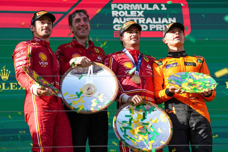 Left to right: Charles Leclerc, Ferrari engineer Mateo Togninalli, Carlos Sainz, and Lando Norris on the podium. AP
