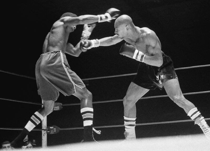 In this November 1974 file photo, Marvin Hagler, right, throws a right at Sugar Ray Seales during a boxing bout in Seattle, which ended in a draw. Hagler, the middleweight boxing great whose title reign and career ended with a split-decision loss to “Sugar” Ray Leonard in 1987, died Saturday, March 13, 2021. He was 66. AP