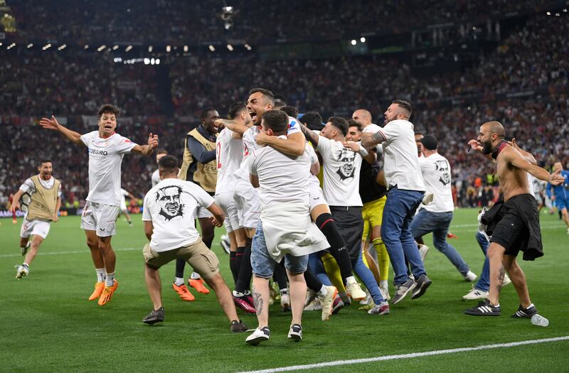 Sevilla's players celebrate with fans. Getty