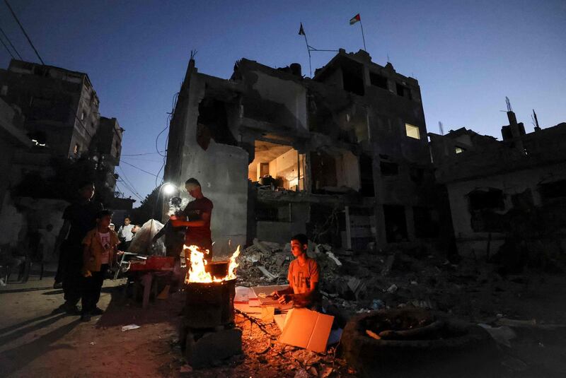Palestinians gather near buildings that were  heavily damaged during the May conflict in Beit Hanun in the northern Gaza Strip. AFP