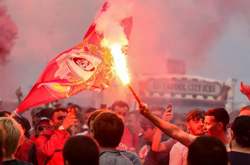Liverpool fans let off flares outside the Liver Building in Liverpool on Friday, June 26. PA