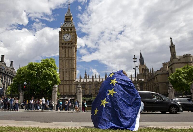 A demonstrator draped in the EU flag protests against the outcome of the UK’s EU referendum in London yesterday. Justin Tallis / AFP 


