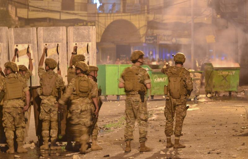 Lebanese soldiers with riot gear react during clashes with anti-government protesters in the northern port city of Tripoli amid fresh demonstrations over a spiralling economic crisis. AFP