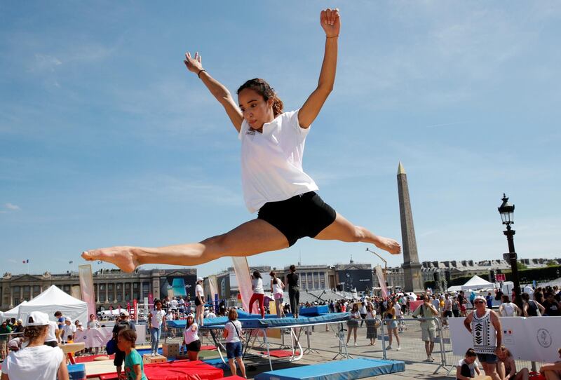 A member of the public takes part in sporting events at Place de la Concorde, which has been turned into a giant Olympic park ahead of the Paris 2024 Olympics, in Paris, France.  Reuters