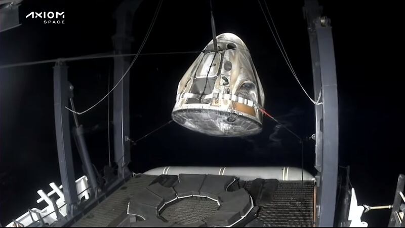 The capsule being lifted onto the boat