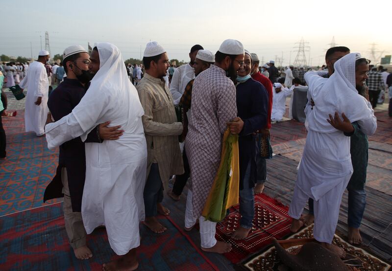 People celebrate and greet each other after attending prayers. EPA 