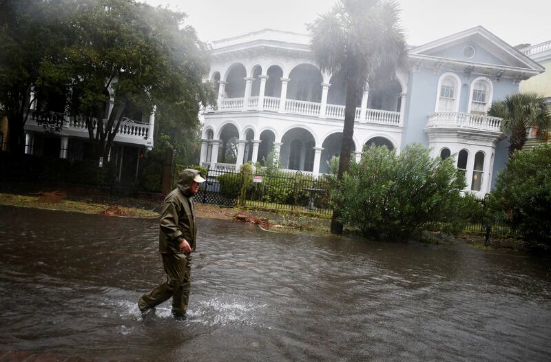 A local resident walks in a flooded street as Hurricane Ian bears down on Charleston. Reuters