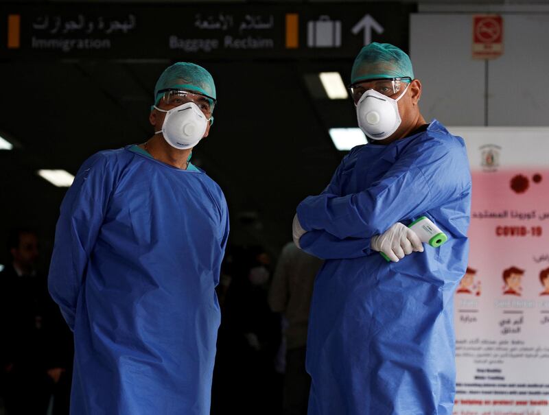 Health officials wait to test passengers at Damascus international airport, Syria March 9, 2020. Reuters