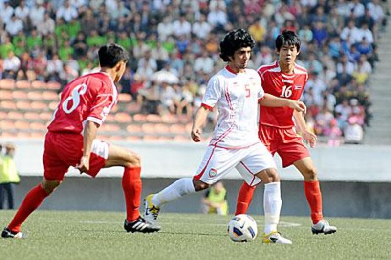 The UAE, in white, hold a one-goal advantage over their opponents North Korea.