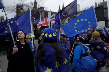 RAnti-Brexit protesters hold European flags and wear European flag design berets as they demonstrate outside the Houses of Parliament in London. AP 