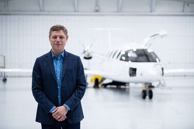 Gregory Davis, Eviation’s president and chief executive, with battery-powered aircraft Alice. AFP



