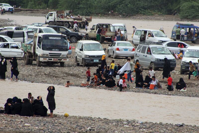 People cool down in the floodwater in Yemen's Lahj Governorate.