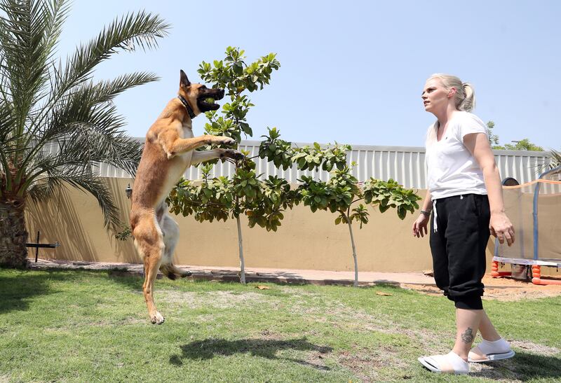 Denny shows his agility playing in the garden with owner Tene Saarva. Dogs on the adoption list have retired from duties or were unable to meet police work demands.
