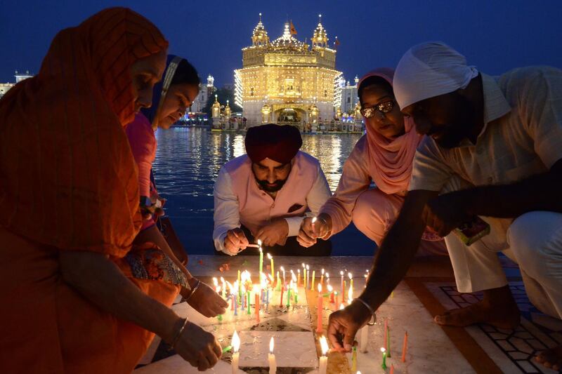 Sikh devotees light candles during Bandi Chhor Divas which coincides with the day of Diwali at the Golden Temple in Amritsar. AFP