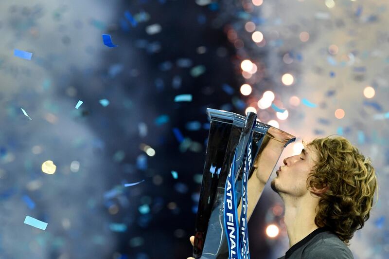 epa07175930 Germany's Alexander Zverev celebrates with his trophy after beating Serbia's Novak Djokovic in their final match at the ATP World Tour Finals tennis tournament  at the O2 Arena in London, Britain, 18 November 2018.  EPA/WILL OLIVER