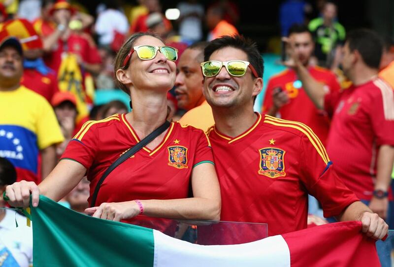 Two Spain fans in Salvador, Brazil. Quinn Rooney / Getty Images