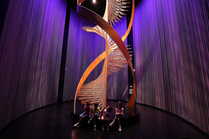 Expo visitors take a rest at the foot of a striking artwork in the Philippines pavilion. Pawan Singh / The National.