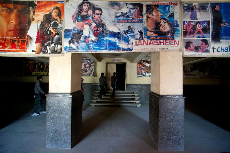 Bollywood movie posters a displayed on a wall as customers enter the Cinema Park theater in the Shar-e-Naw district of Kabul on May 1, 2012. The Cinema Park theatre  has 544 seats and features Indian films mostly running two times a day in the morning.  AFP PHOTO/JOHANNES EISELE (Photo by JOHANNES EISELE / AFP)