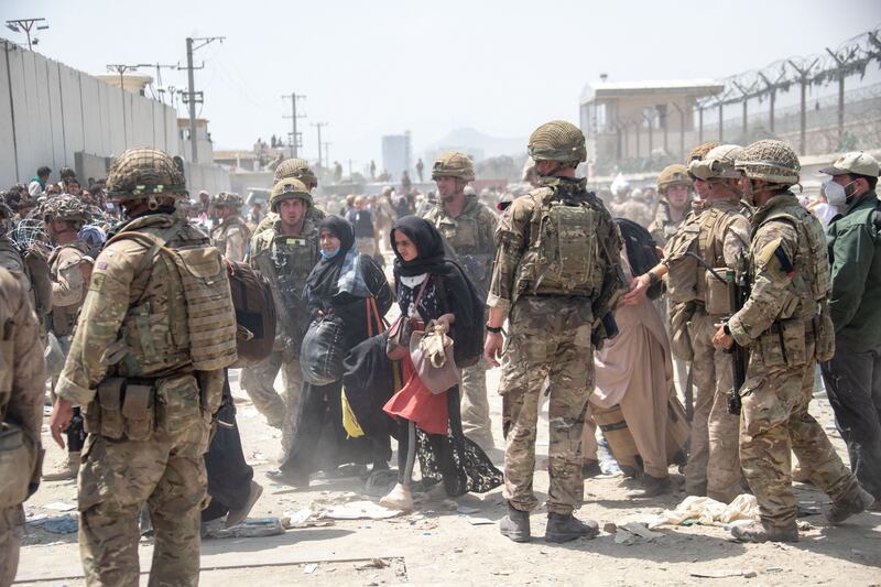Members of the British and US Armed Forces assisting with evacuations at Kabul Airport in August.  AP