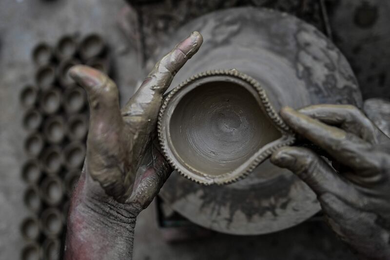Potters make diyas or earthen oil lamps in New Delhi. AFP