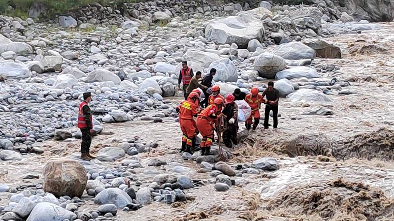 Rescuers move people to safety in Luding county on Tuesday. EPA