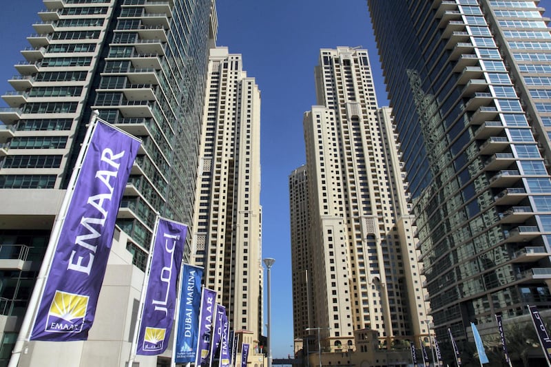 Flags of Emaar Properties PJSC, builder of the world's tallest skyscraper, fly near high-rise properties in the Marina district of Dubai, United Arab Emirates, on Saturday, Dec. 10, 2011. Dubai and its state-owned non-financial companies have $101.5 billion of outstanding debt and may need further financial support to meet those obligations, Moody's said. Photographer: Gabriela Maj/Bloomberg

