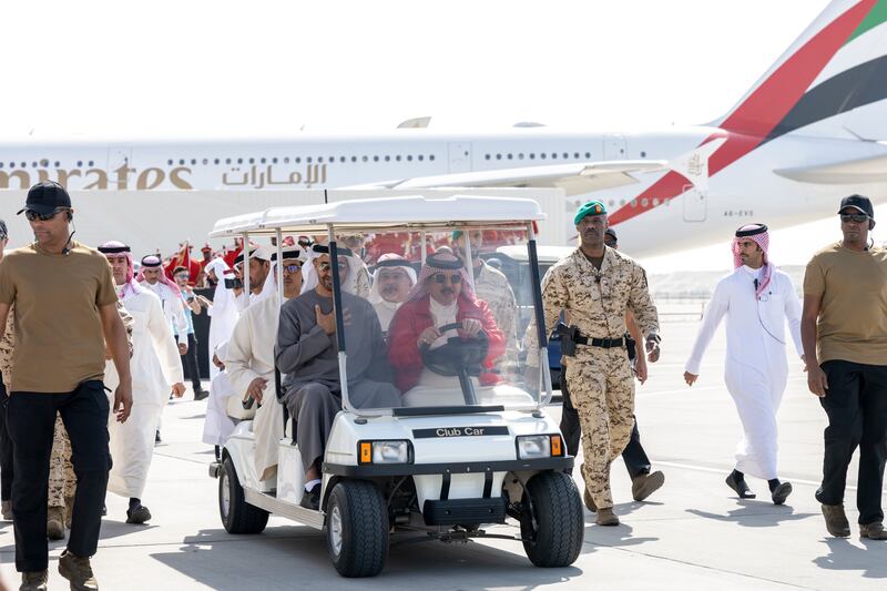 President Sheikh Mohamed and King Hamad of Bahrain ride in a vehicle on a tour of the airshow. 