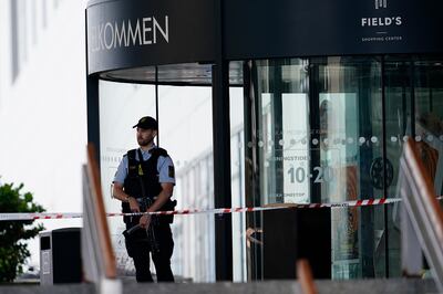 A police officer stands in front of the closed Field's shopping mall in Copenhagen, Denmark, on Monday.  AP