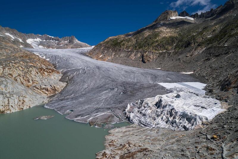 (FILES) This file photograph taken on August 16, 2018, shows the Rhone Glacier and its glacial lake, near Gletsch.
 Avoiding global climate chaos will require a major transformation of society and the world economy that is "unprecedented in scale," the UN said October 8, 2018, in a landmark report that warns time is running out to avert disaster. / AFP / Fabrice COFFRINI
