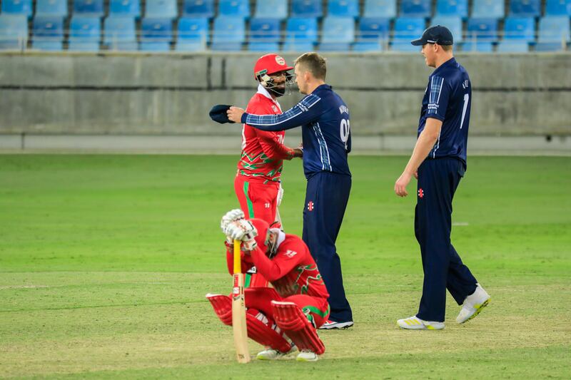 Scotland and Oman players greet each other at the end of the game in Dubai. Photo: ICC