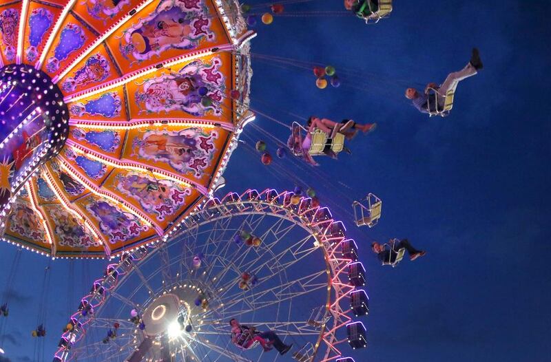 Visitors ride on a swing and on a Ferris wheel at the 581st ‘Cranger Kirmes’ funfair in Herne, Germany. Ina Fassbender / EPA
