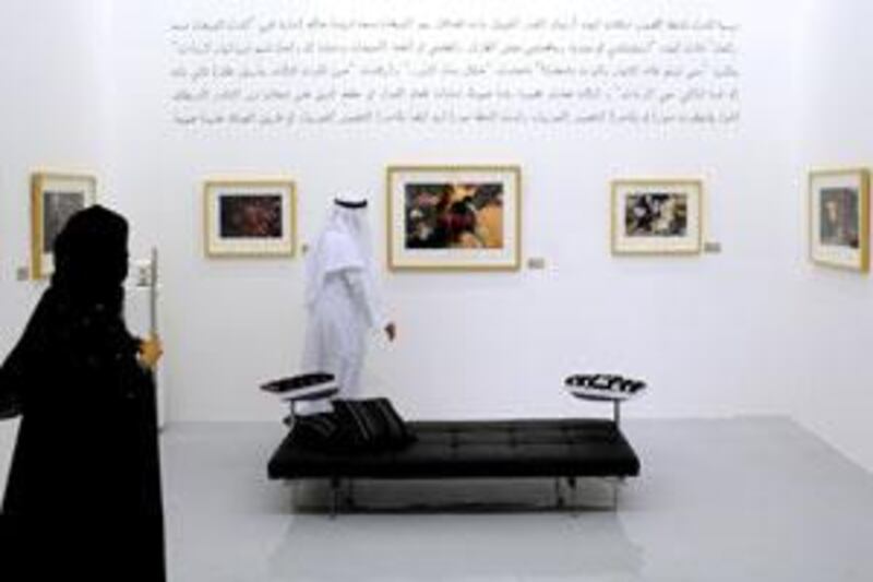 Visitors at The Empty Quarter gallery in Dubai look at an exhibition of photos of the 1971 Maktoum family royal wedding taken by the American photographer Eve Arnold.