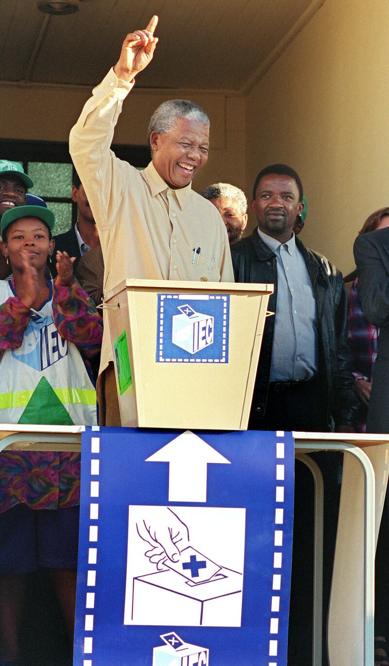 African National Congress (ANC) President Nelson Mandela smiles broadly 27 April 1994 in Oshlange, black township near Durban, as he casts his historic vote during South Africa's first democratic and all-race general elections.