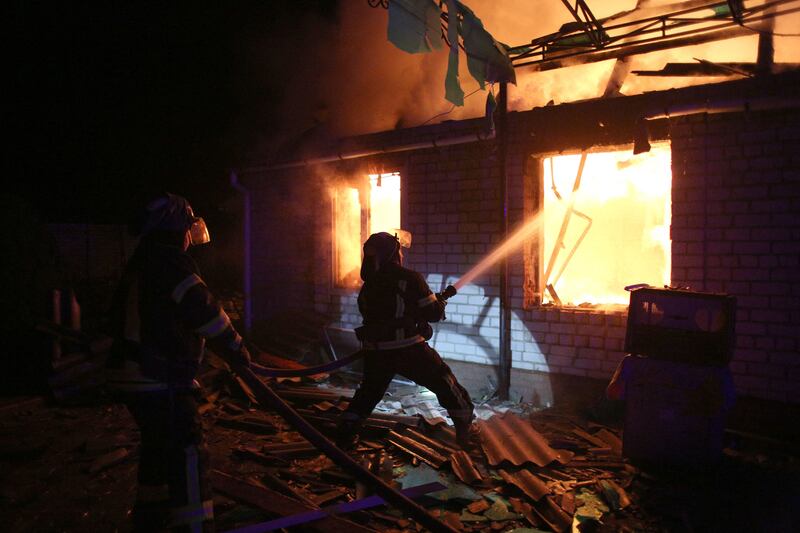 Firefighters extinguish a blaze at a house in Muratovo, in Ukraine's Luhansk enclave. AFP