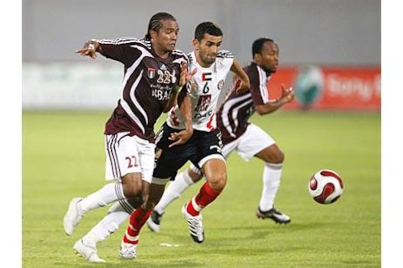 A derby day battle as Al Wahda's Pinga (left) challenges Al Jazira's Rashed Abdulrahman.