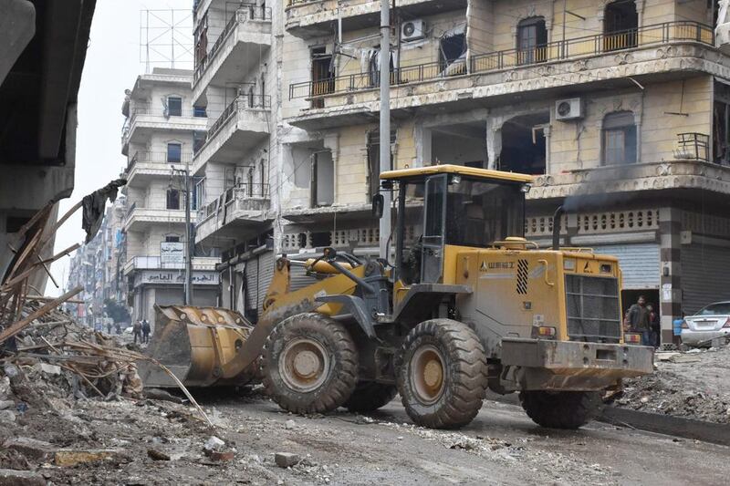 Tractors are seen as the Syrian government starts to clean up areas formerly held by opposition forces in the northern city of Aleppo on December 27, 2016. AFP / George OURFALIAN

