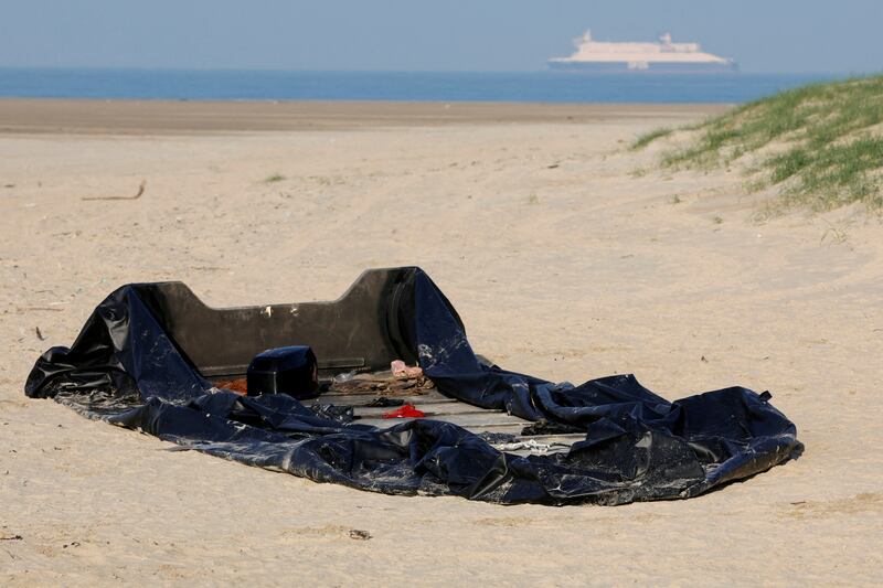 A damaged inflatable dinghy on a beach in Gravelines, a departure point for trying to reach the UK from France. Reuters