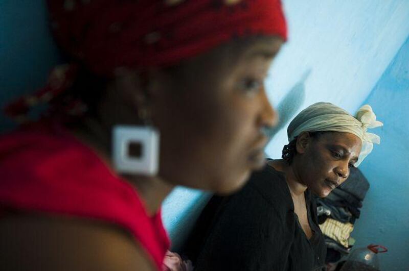 The Liberian national Fatou Jallah, left, with her sister Nina at their home in Senegal is not following the Charles Taylor trial and wishes people could just move on.