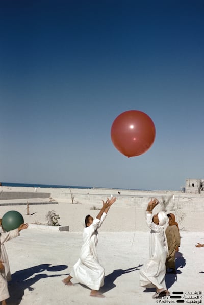 Children playing with balloons outside the Abu Dhabi Marine Areas house in Abu Dhabi in the early 1960s. Photo: Dr Alan Horan © UAE National Library and Archives