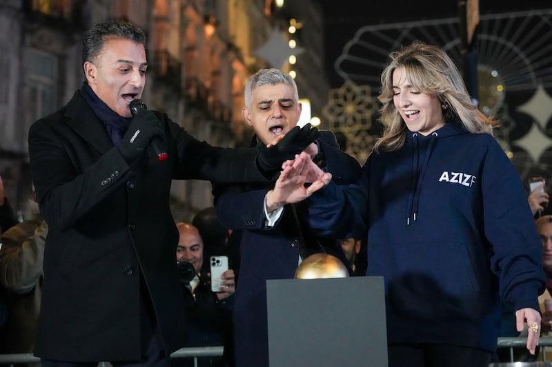 Sadiq Khan, the Mayor of London, helps to put on the lights in the city centre. Reuters